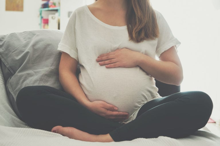 Pregnant woman holding her stomach