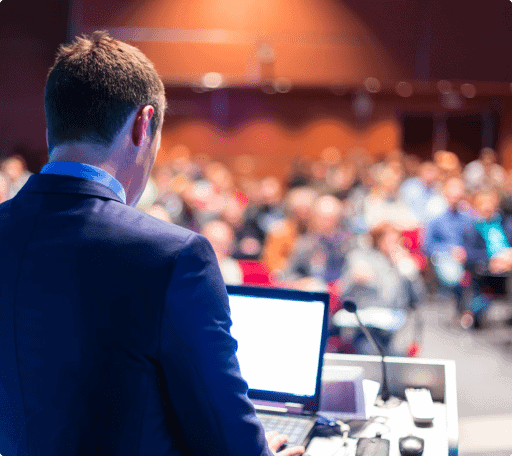 Man standing in front of audience presenting at a conference