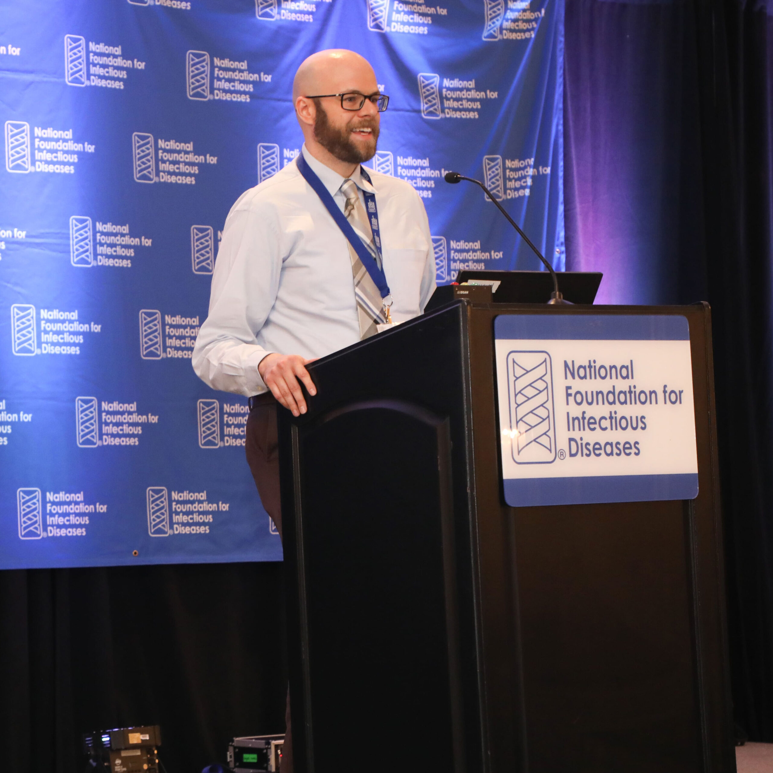 A man stands behind a podium.