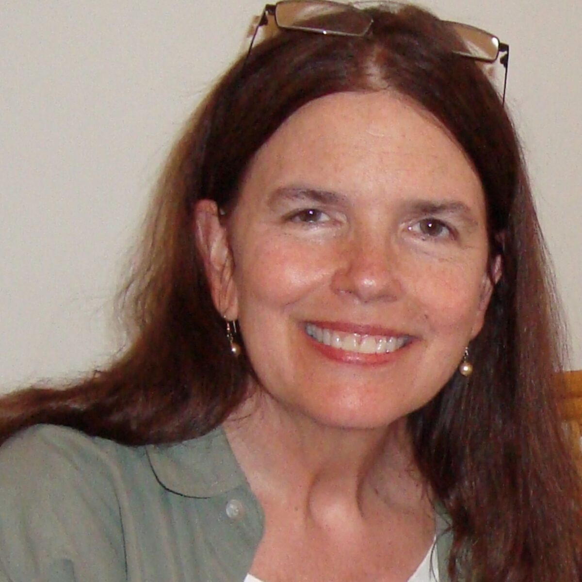 A woman with long brown hair smiles