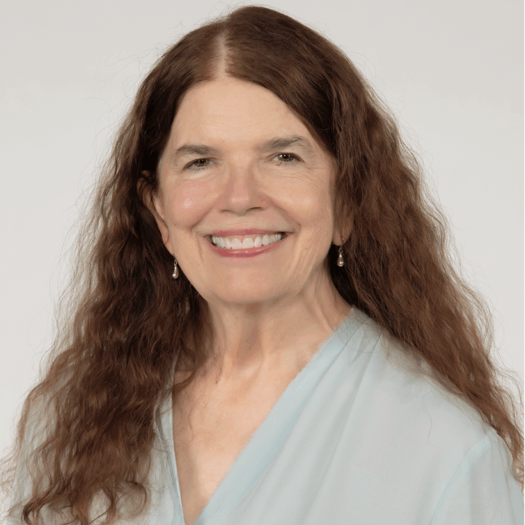 A woman with long brown hair smiles