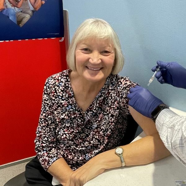 Kathy Harriman smiles at the camera while getting her annual flu vaccine