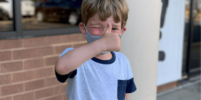 Max-gets-vaccinated Little boy in baseball cap looks out at water