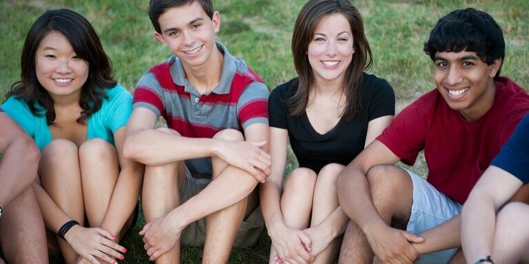 Group of Multi-ethnic happy teenagers outside Teens or adolescents