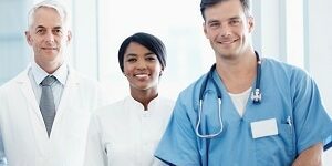 Group of successful multi ethnic medical professionals smiling while standing together side by side